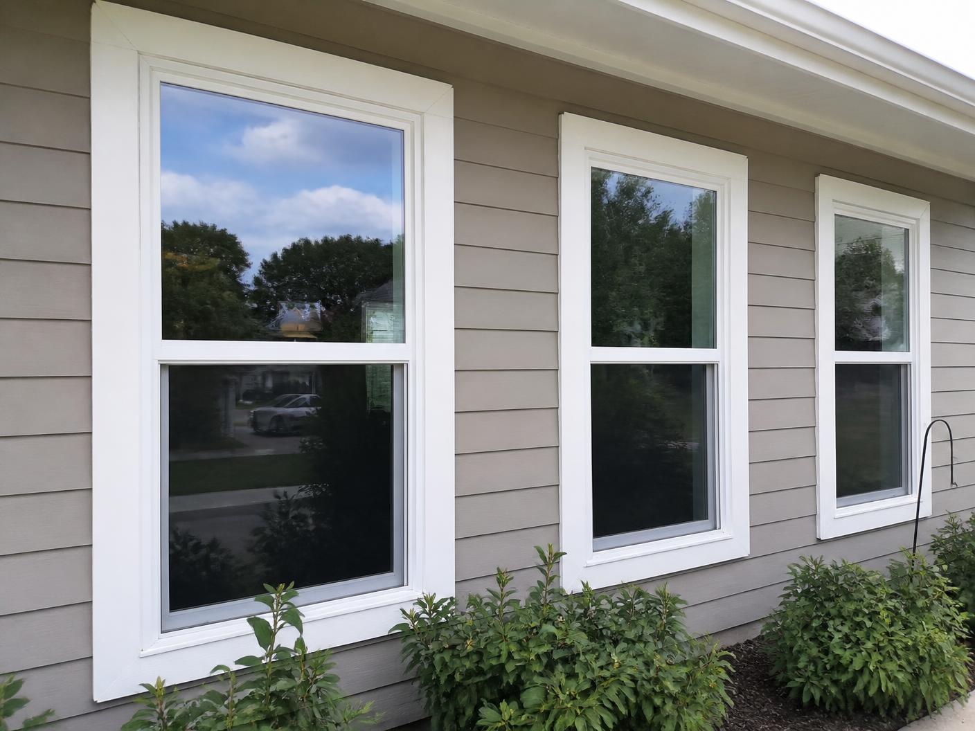 Illustrative photo of newly installed replacement windows with white trim